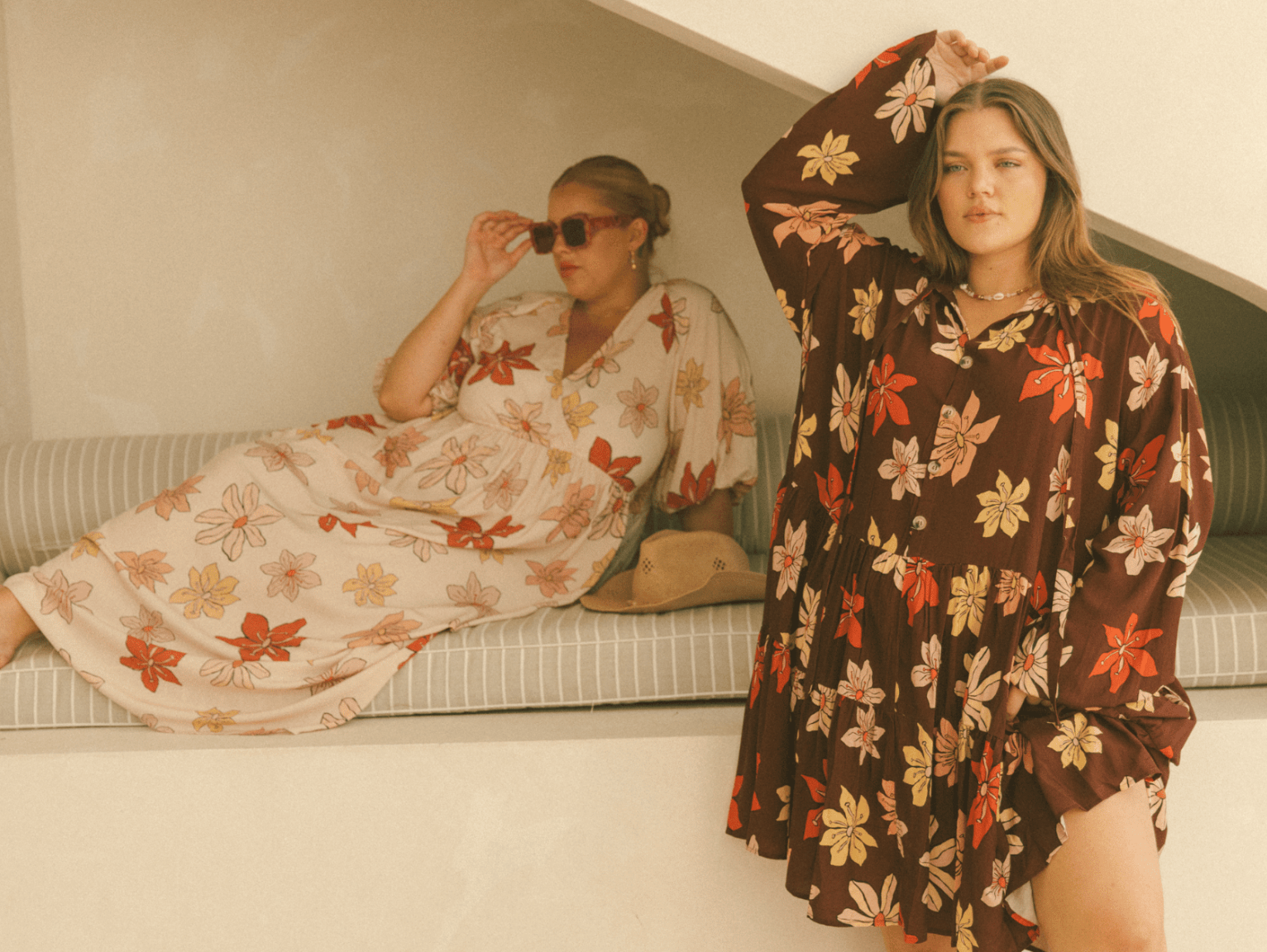 Effortless autumn outfits featuring The Lullaby Club's Desert Sun collection. Two women in chic floral maxi dresses with warm-toned prints, perfect for seasonal style. Soft, flowy silhouettes designed for comfort and versatility, ideal for maternity, post
