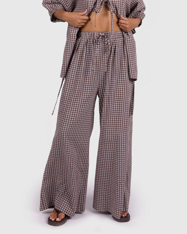 Woman wearing a checkered outfit on a white background