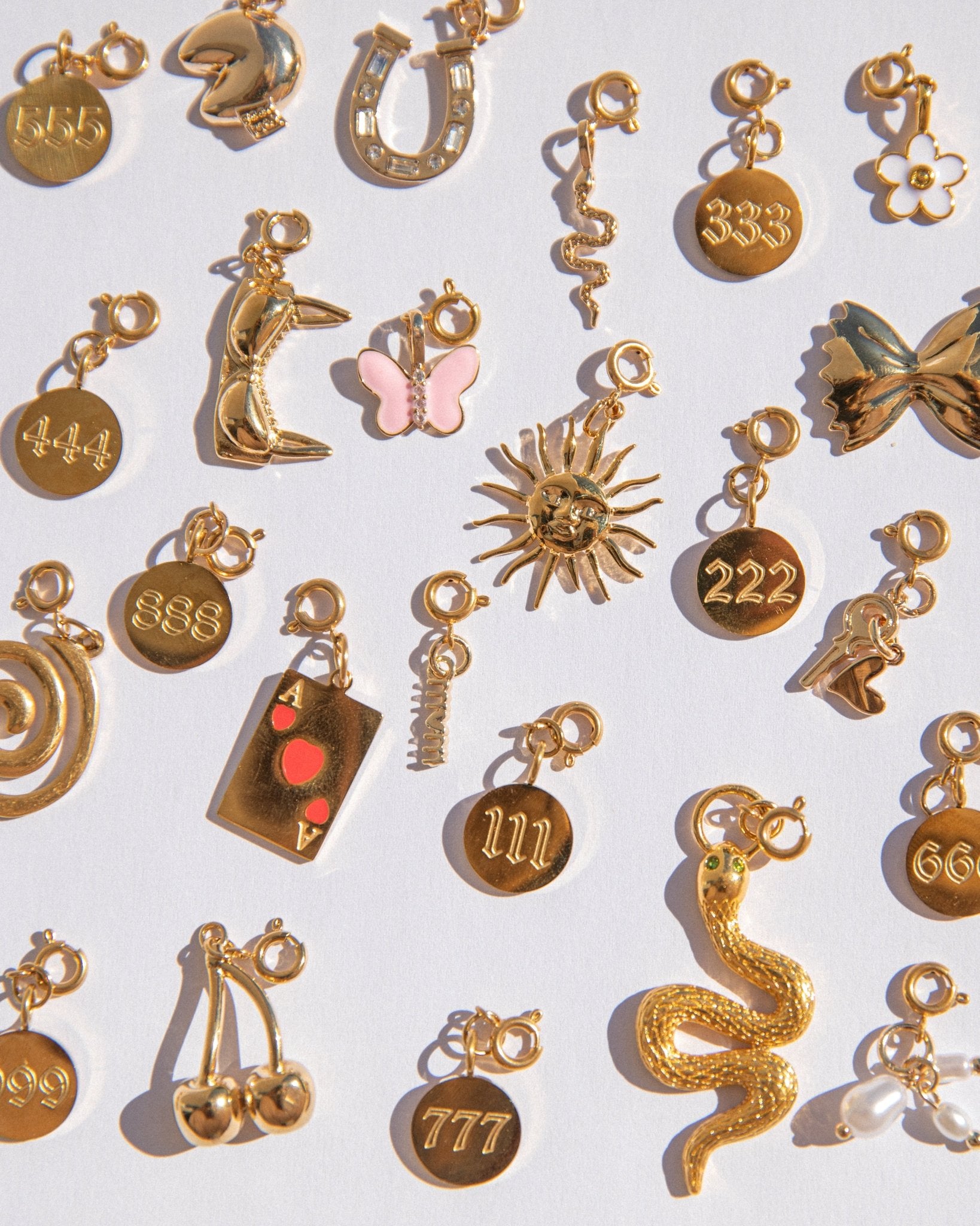 Collection of various gold charms on a white background