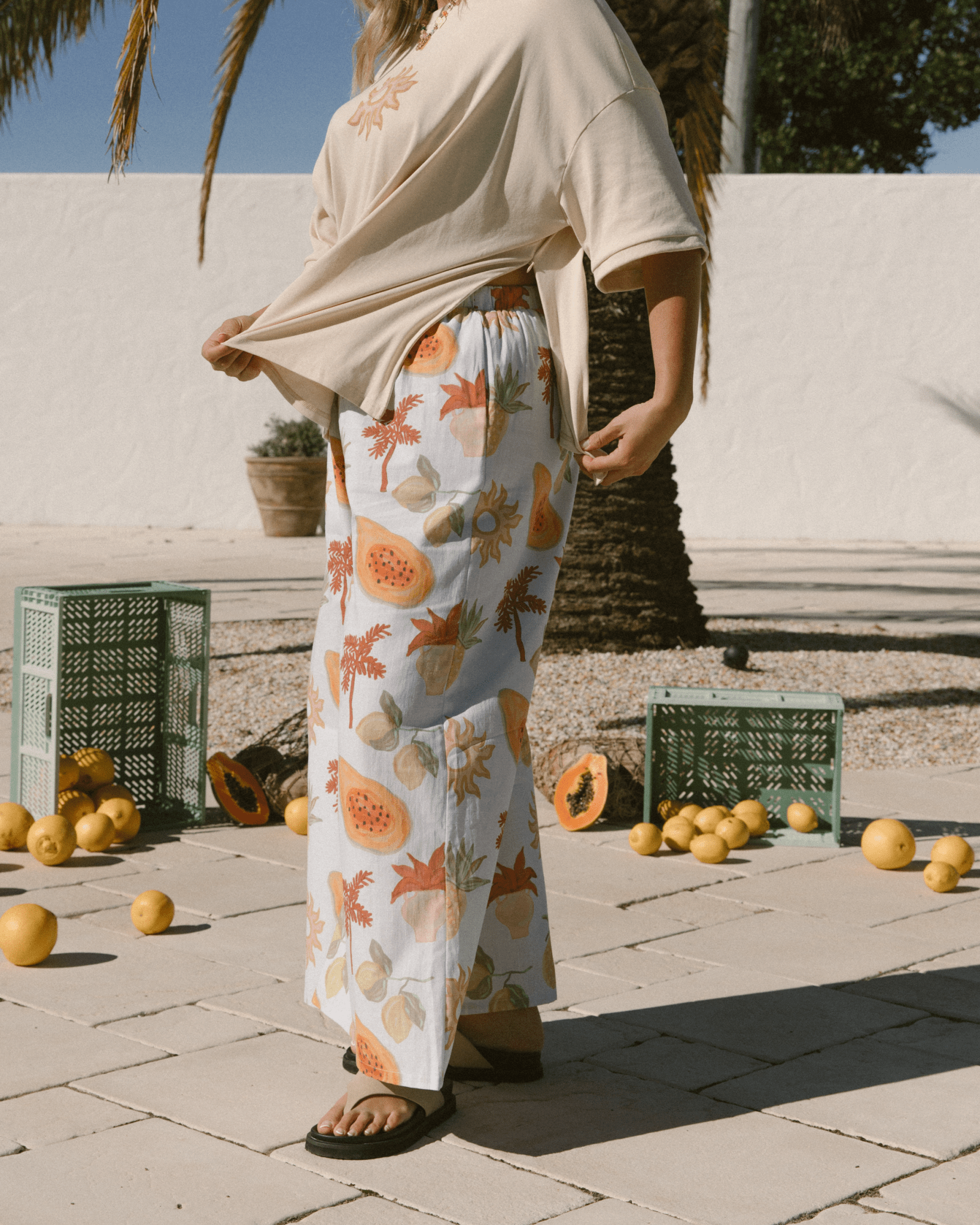 Woman unzipping the hidden sideseam breastfeeding zipper on oversized beige tshirt