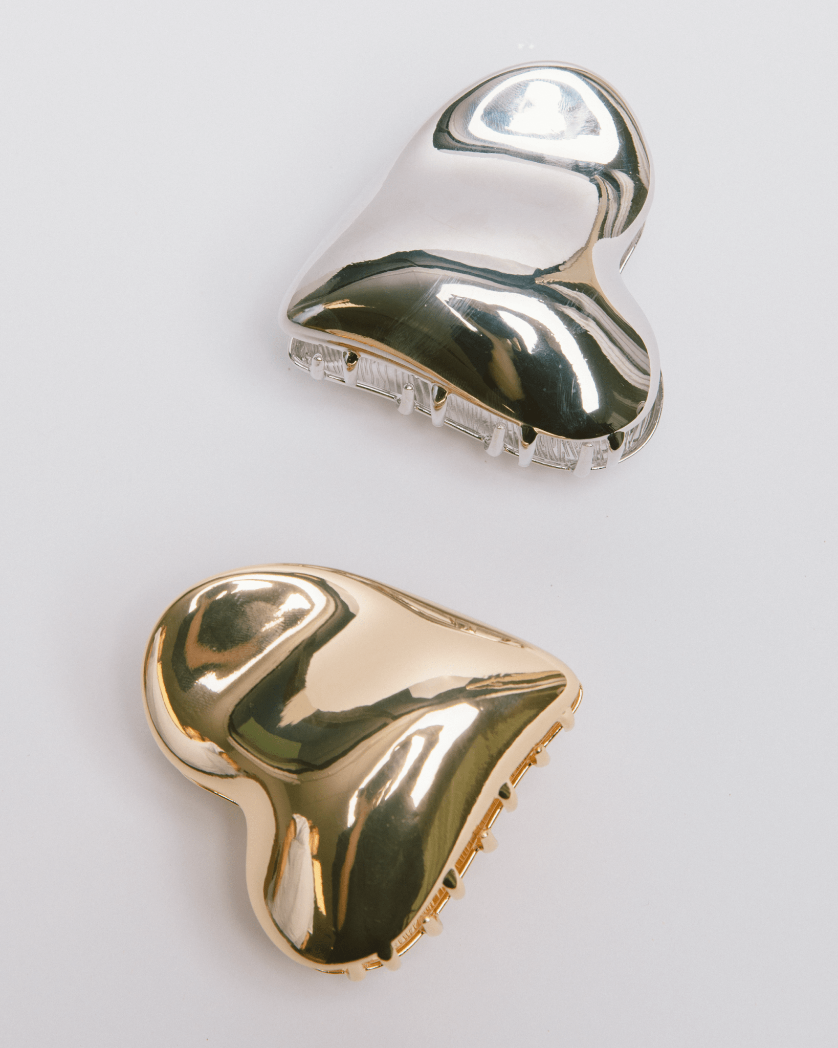 Gold and silver heart-shaped metal hair clips.
