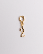 A gold-colored charm in the shape of the number 2 with a secure clasp designed for attaching to jewelry items.