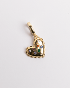 A gold-plated stainless steel heart-shaped charm with multicolored gemstones inlayed on it.