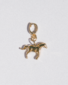 Gold horse charm on a white background
