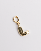 A gold-plated stainless steel charm in the shape of the letter L with a secure clasp designed for attaching to necklaces or bracelets.