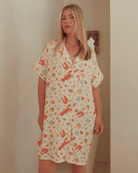 Woman wearing a summery, breathable, short-sleeved nightie in a christmas pattern.