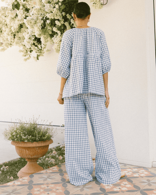 Back view of The Lullaby Club Posey Pants in Blue Gingham, highlighting the comfortable oversized silhouette and deep pockets